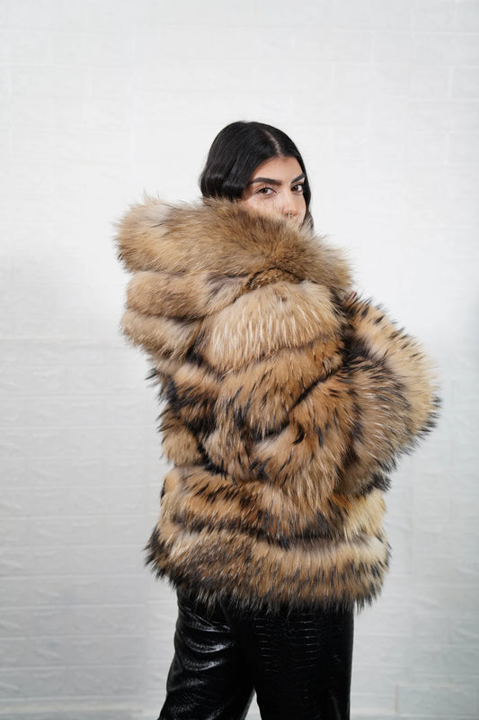Finn raccoon fur jacket natural displaying full skin Finnish raccoon horizontal rows with clean leather strips and hip level hooded silhouette — Greek craftsmanship, TatiFurs