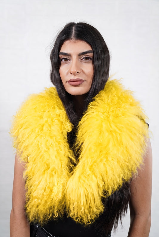 Mongolian Sheepskin Collar Yellow — Curly Lamb Fur worn by a woman, front view of the long curly warm sunflower yellow Tibetan lamb fur framing the face and shoulders, TatiFurs