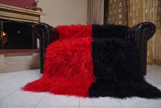 Mongolian Blanket Throw Red Black Two Tone — Wool Sheepskin spread across the leather sofa showing the whole scarlet red and jet black Mongolian wool surface — Greek craftsmanship, TatiFurs