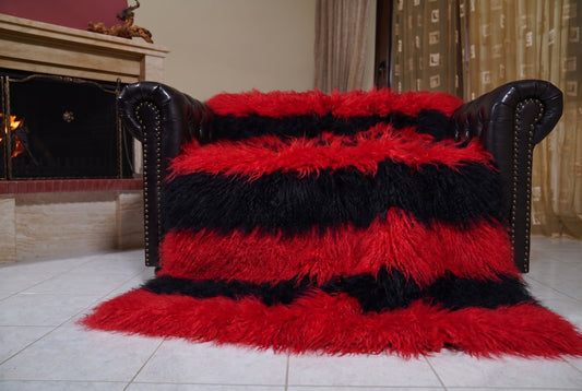 Mongolian Blanket Throw Red Black Striped — Wool Sheepskin spread across the leather sofa showing the whole scarlet red and jet black Mongolian wool surface — Greek craftsmanship, TatiFurs