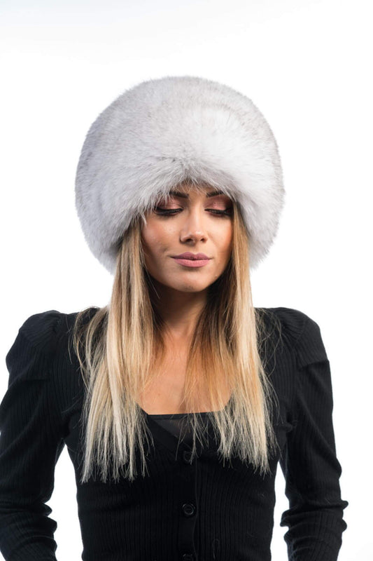 Woman wearing natural blue fox fur full skin hat showing smoky blue-grey tones