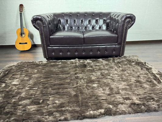 Close-up of gold brown Rex rabbit fur texture showing uniformly dense pile and radiant warm colour depth