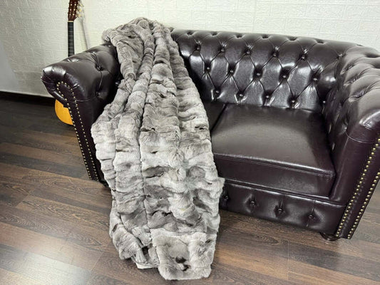Rabbit Blanket Throw Rex Gray Black Spots - Tatifurs draped over a black leather couch.