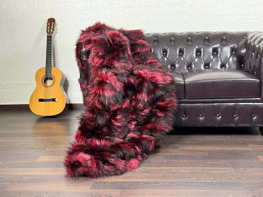Fox Fur Blanket Throw Double Sided Black Red - Tatifurs draped over a couch with a guitar in the background.