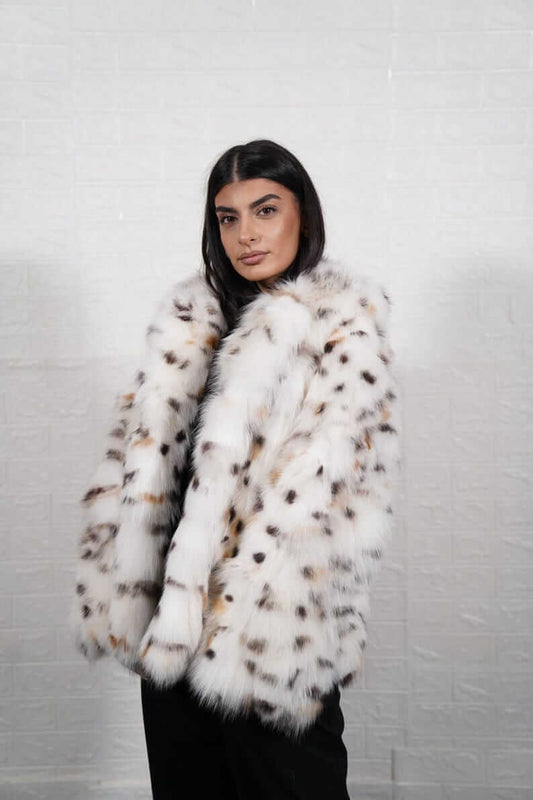 Close-up of white fox fur texture and leopard print collar detail