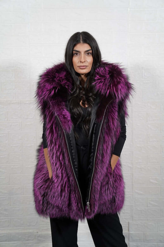 Woman wearing purple and black fox fur hooded vest with zipper closure