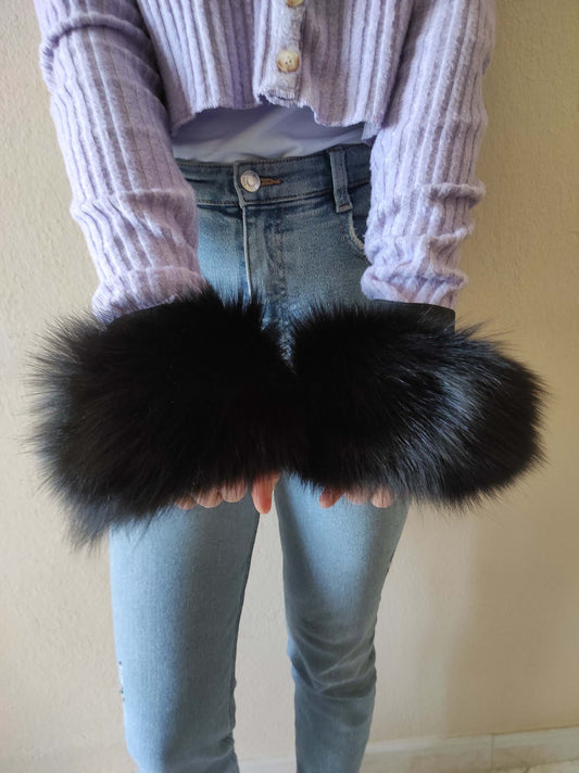 Black Fox Fur Cuffs - Tatifurs displayed in hands, showcasing the luxurious black fur.