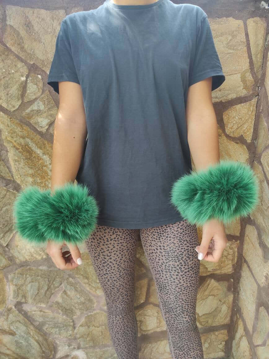 Green Fox Fur Cuffs – 100% Real Fur - Tatifurs showcased on a model wearing a black t-shirt and animal print pants.