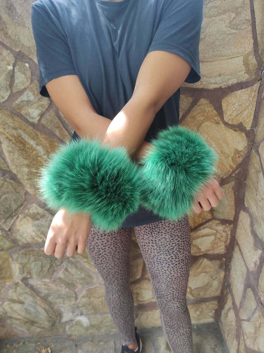 Green Fox Fur Cuffs – 100% Real Fur - Tatifurs showcased on model against a stone wall.