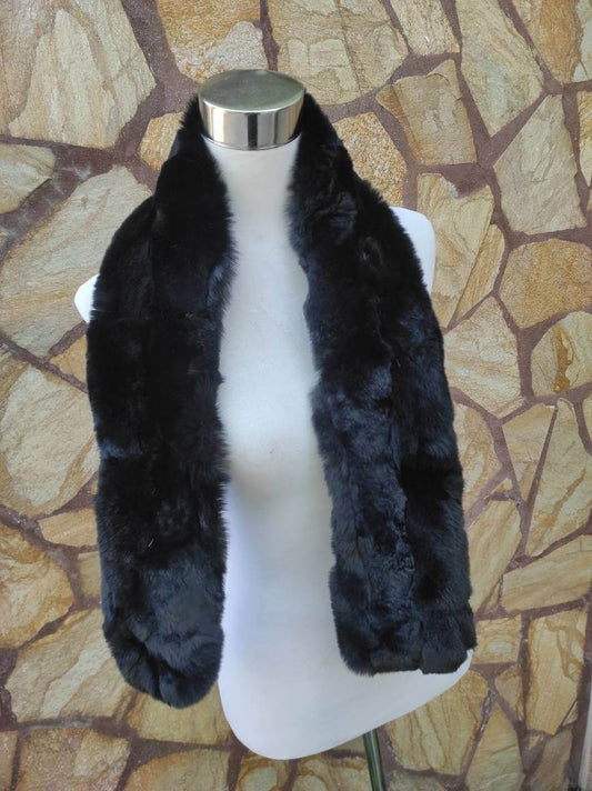 Rex Rabbit Fur Scarf Black - Tatifurs displayed on a mannequin against a textured background, showcasing its rich black color.
