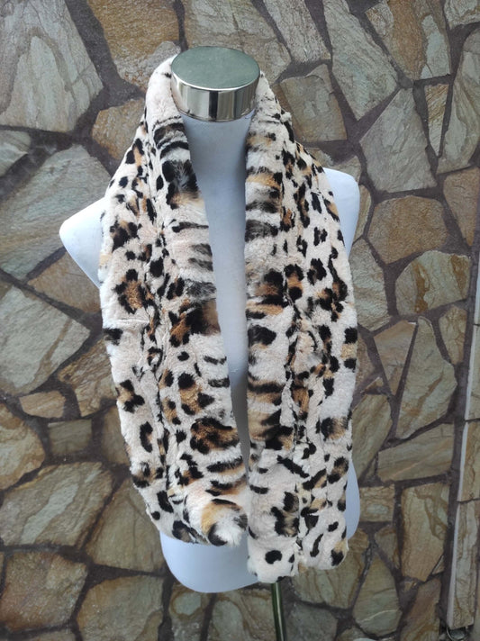 Woman wearing beige leopard print rex rabbit fur scarf pulled through hole for elegant fit