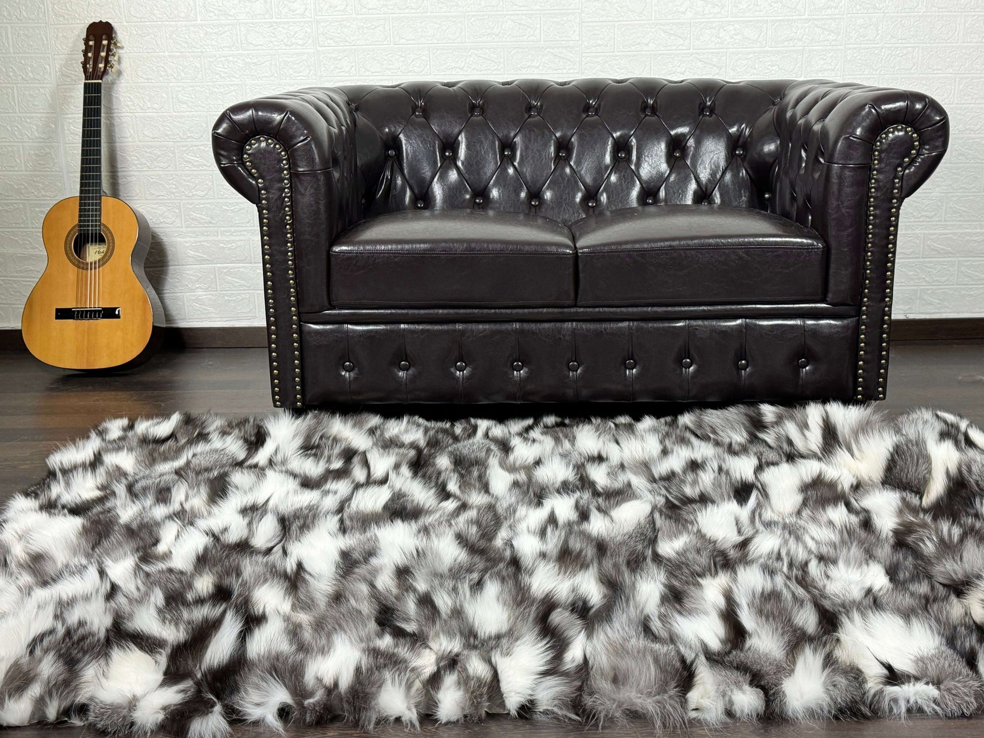 Fox Fur Blanket Throw Black Silver White - Tatifurs displayed on floor near a leather sofa and guitar.