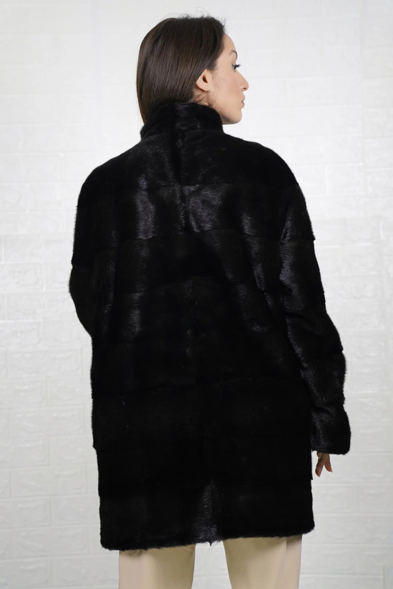 Mink fur coat black shown from the back displaying full above the knee silhouette and deep consistent black skin on skin mink flow — Greek craftsmanship, TatiFurs

