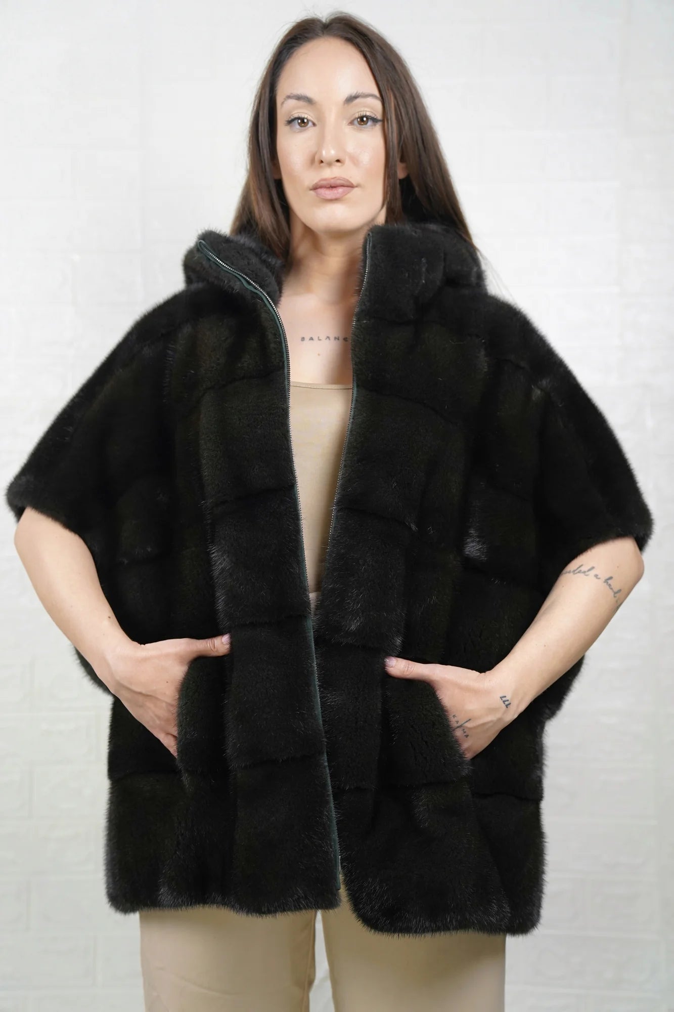 Mink fur cape dark green women shown full length from front displaying sleeveless silhouette and deep dark green skin on skin flow
