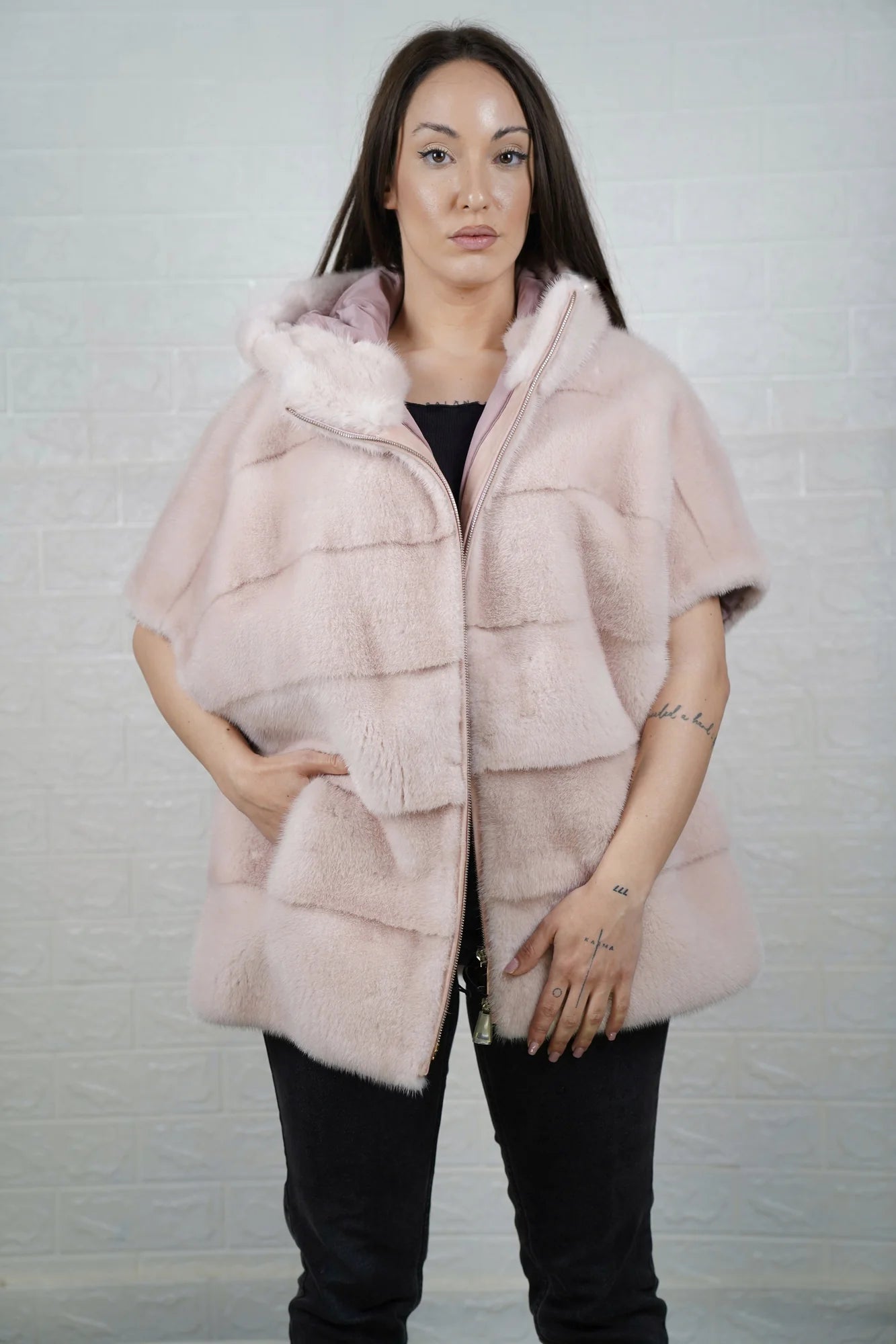 Mink fur cape pink with hood raised showing soft pink mink framing the face and short sleeve construction detail
