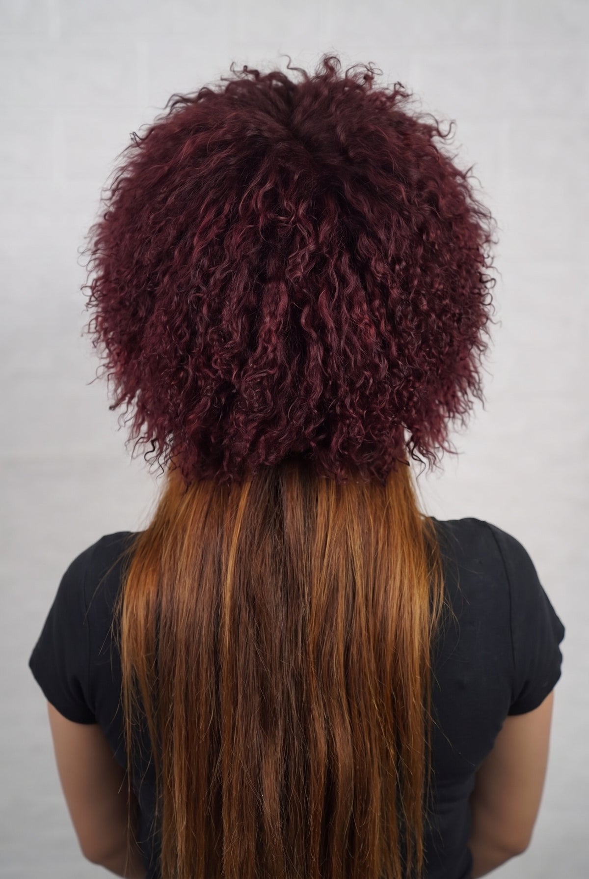 Mongolian Sheepskin Hat Burgundy — Curly Lamb Fur, One Size shown from the back, dense deep oxblood burgundy Mongolian sheepskin pile from crown to nape — TatiFurs