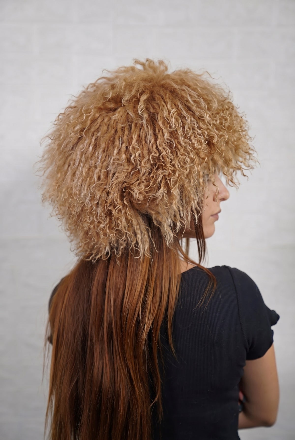 Mongolian Sheepskin Hat Camel Brown — Curly Lamb Fur, One Size three-quarter back view showing the warm natural camel brown curls covering the crown and nape — Greek craftsmanship, TatiFurs