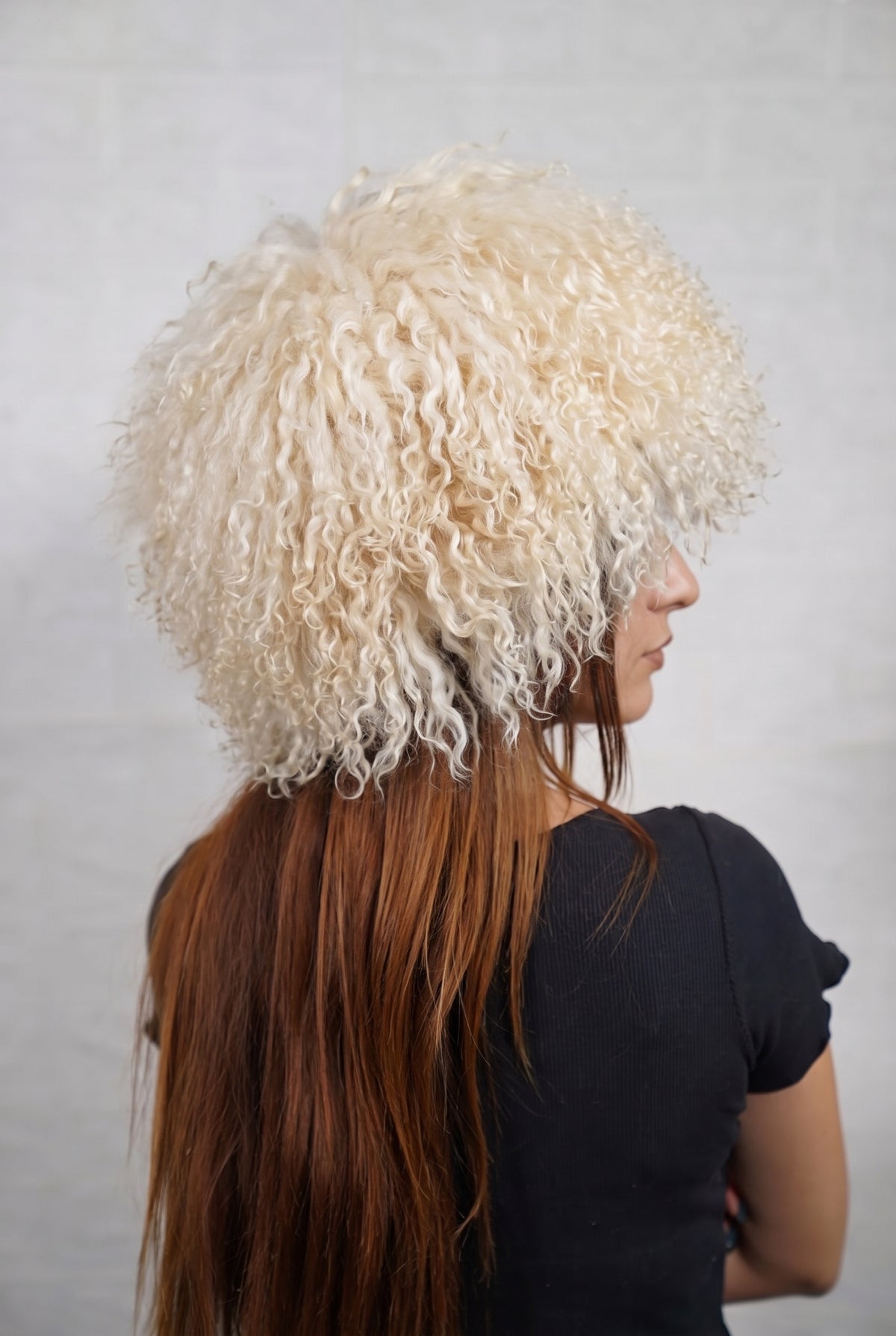 Mongolian Sheepskin Hat Cream Beige — Curly Lamb Fur, One Size three-quarter back view showing the soft cream beige curls covering the crown and nape — Greek craftsmanship, TatiFurs