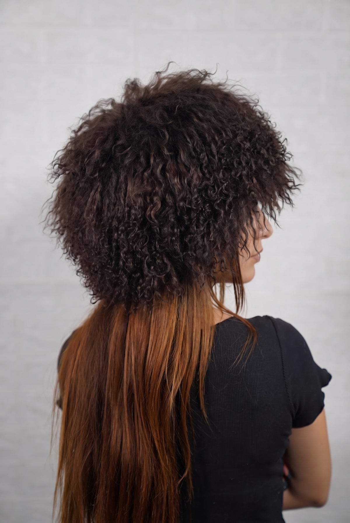 Mongolian Sheepskin Hat Dark Brown — Curly Lamb Fur, One Size three-quarter back view showing the deep chocolate brown curls covering the crown and nape — Greek craftsmanship, TatiFurs