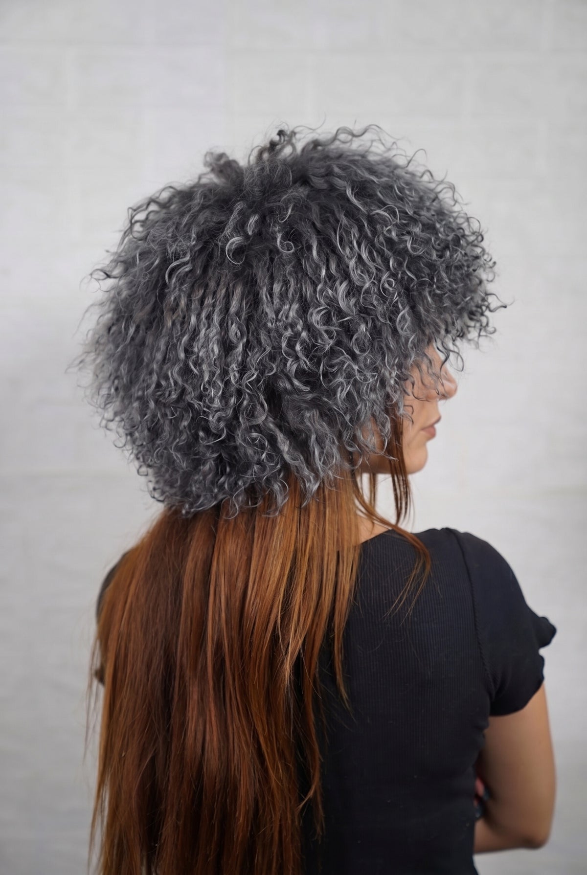 Mongolian Sheepskin Hat Grey — Curly Lamb Fur, One Size three-quarter back view showing the smoky charcoal grey curls covering the crown and nape — Greek craftsmanship, TatiFurs