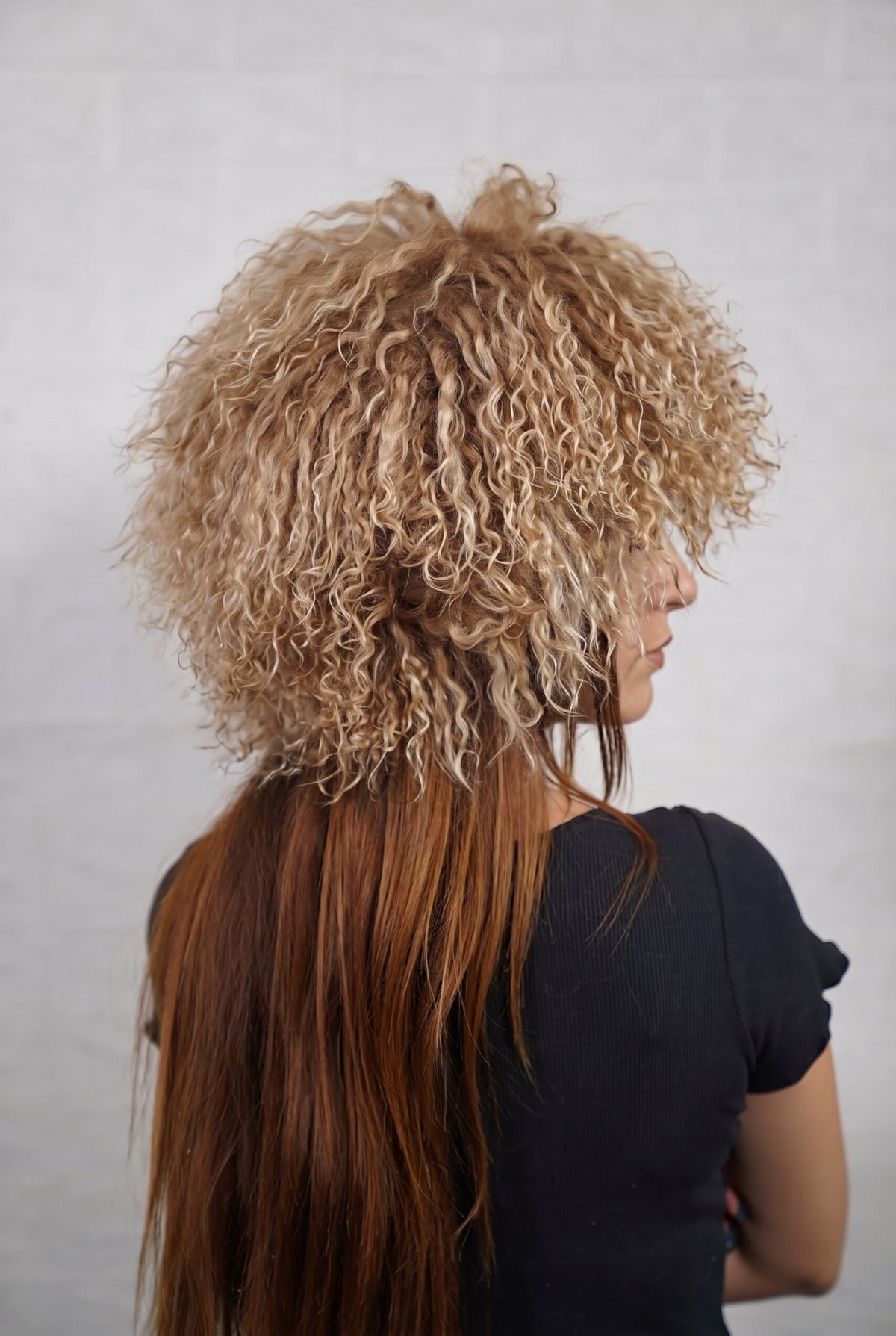 Mongolian Sheepskin Hat Light Brown — Curly Lamb Fur, One Size three-quarter back view showing the milky caramel light brown curls covering the crown and nape — Greek craftsmanship, TatiFurs