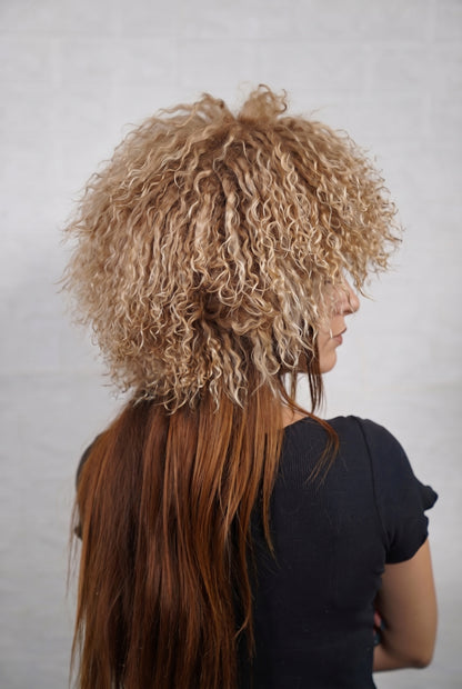 Mongolian Sheepskin Hat Light Brown — Curly Lamb Fur, One Size three-quarter back view showing the milky caramel light brown curls covering the crown and nape — Greek craftsmanship, TatiFurs