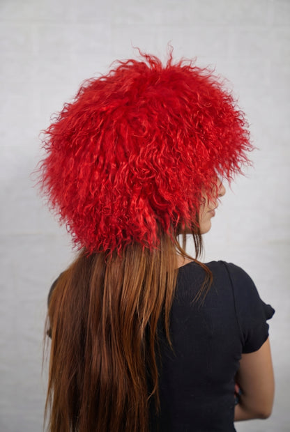 Mongolian Sheepskin Hat Red — Curly Lamb Fur, One Size three-quarter back view showing the vivid scarlet red curls covering the crown and nape — Greek craftsmanship, TatiFurs