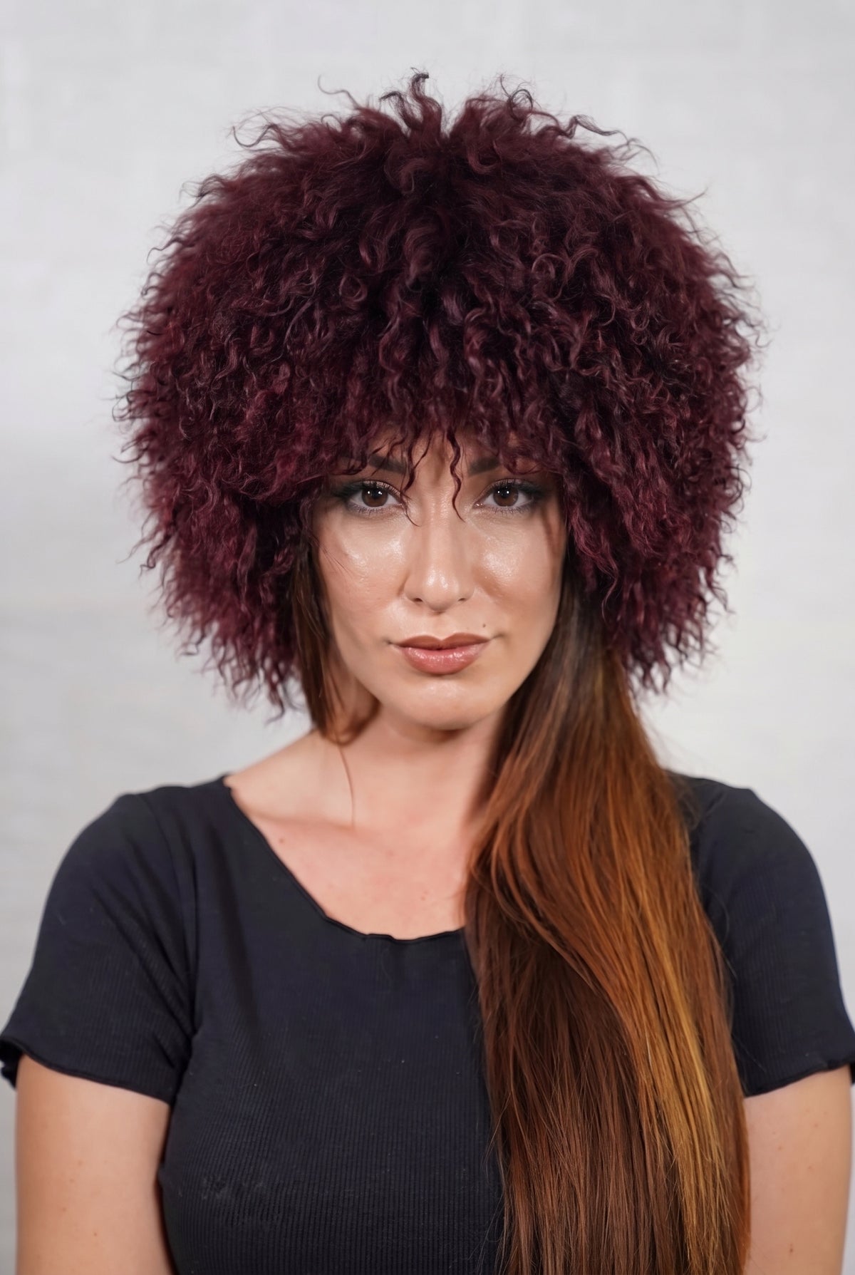 Mongolian Sheepskin Hat Burgundy — Curly Lamb Fur, One Size shown from the front, full round silhouette of deep oxblood burgundy Mongolian lamb curls over the forehead — handmade in Greece, TatiFurs