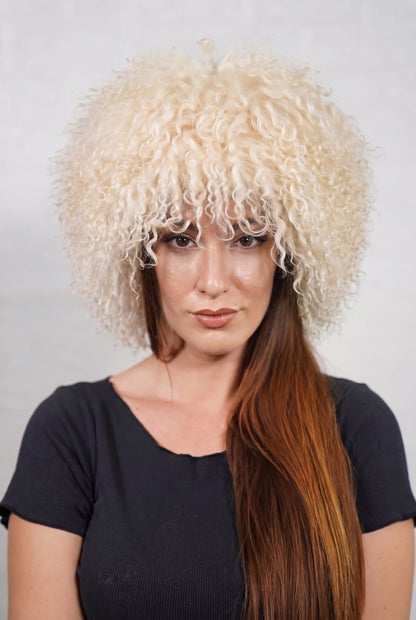 Mongolian Sheepskin Hat Cream Beige — Curly Lamb Fur, One Size shown from the front, full round silhouette of soft cream beige Mongolian lamb curls over the forehead — handmade in Greece, TatiFurs