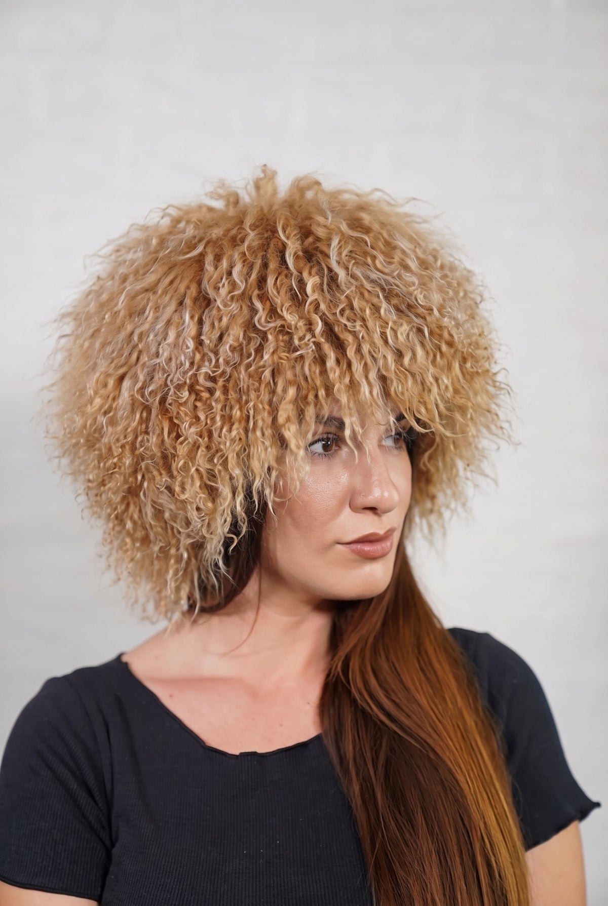 Mongolian Sheepskin Hat Camel Brown — Curly Lamb Fur, One Size in profile displaying the volume and length of the warm natural camel brown curly sheepskin pile over the ear — TatiFurs