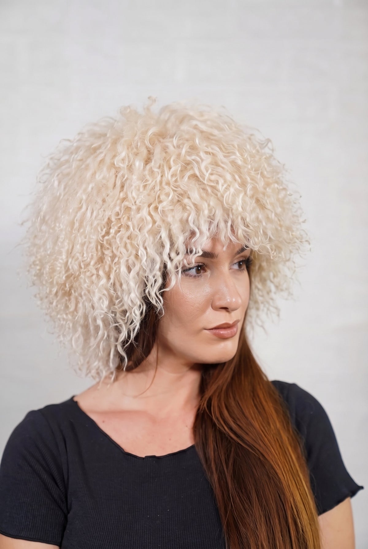 Mongolian Sheepskin Hat Cream Beige — Curly Lamb Fur, One Size in profile displaying the volume and length of the soft cream beige curly sheepskin pile over the ear — TatiFurs