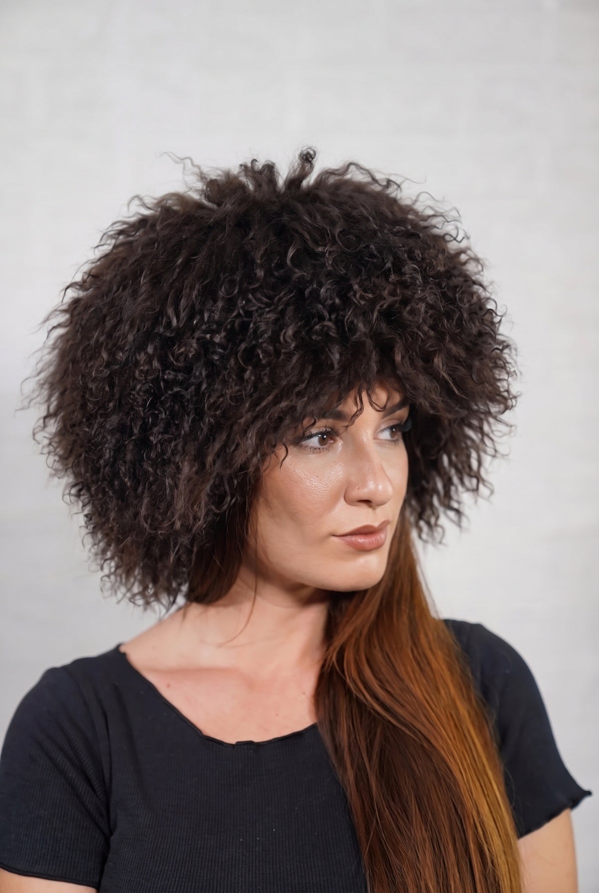 Mongolian Sheepskin Hat Dark Brown — Curly Lamb Fur, One Size in profile displaying the volume and length of the deep chocolate brown curly sheepskin pile over the ear — TatiFurs