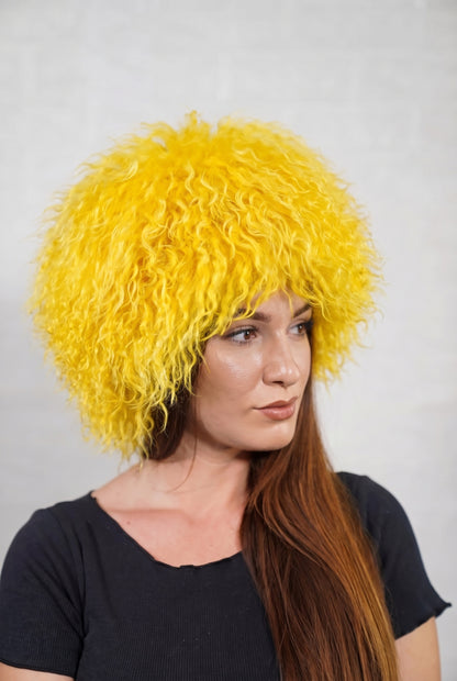 Mongolian Sheepskin Hat Yellow — Curly Lamb Fur, One Size in profile displaying the volume and length of the warm sunflower yellow curly sheepskin pile over the ear — TatiFurs