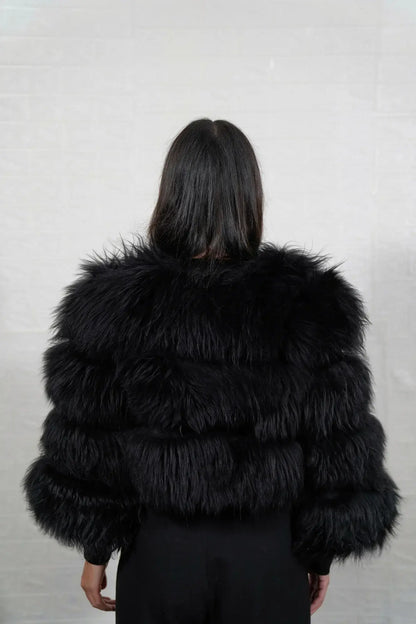 Alpaca fur jacket black shown from the back displaying full cropped bomber silhouette and horizontal leather strip construction across black alpaca rows — Greek craftsmanship, TatiFurs
