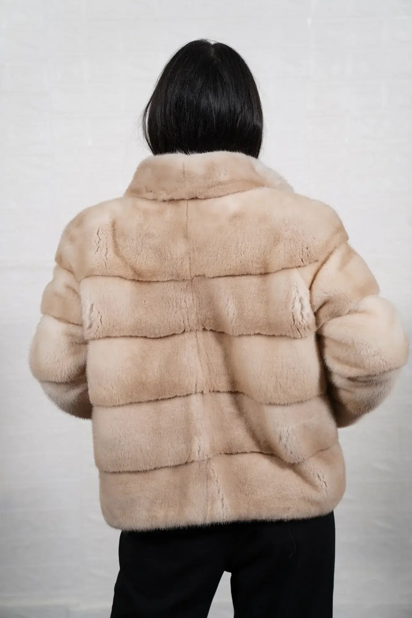 Mink fur jacket pastel beige shown from the side displaying hip level silhouette and soft natural pastel beige mink drape — Greek craftsmanship, TatiFurs
