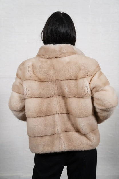 Mink fur jacket pastel beige shown from the side displaying hip level silhouette and soft natural pastel beige mink drape — Greek craftsmanship, TatiFurs
