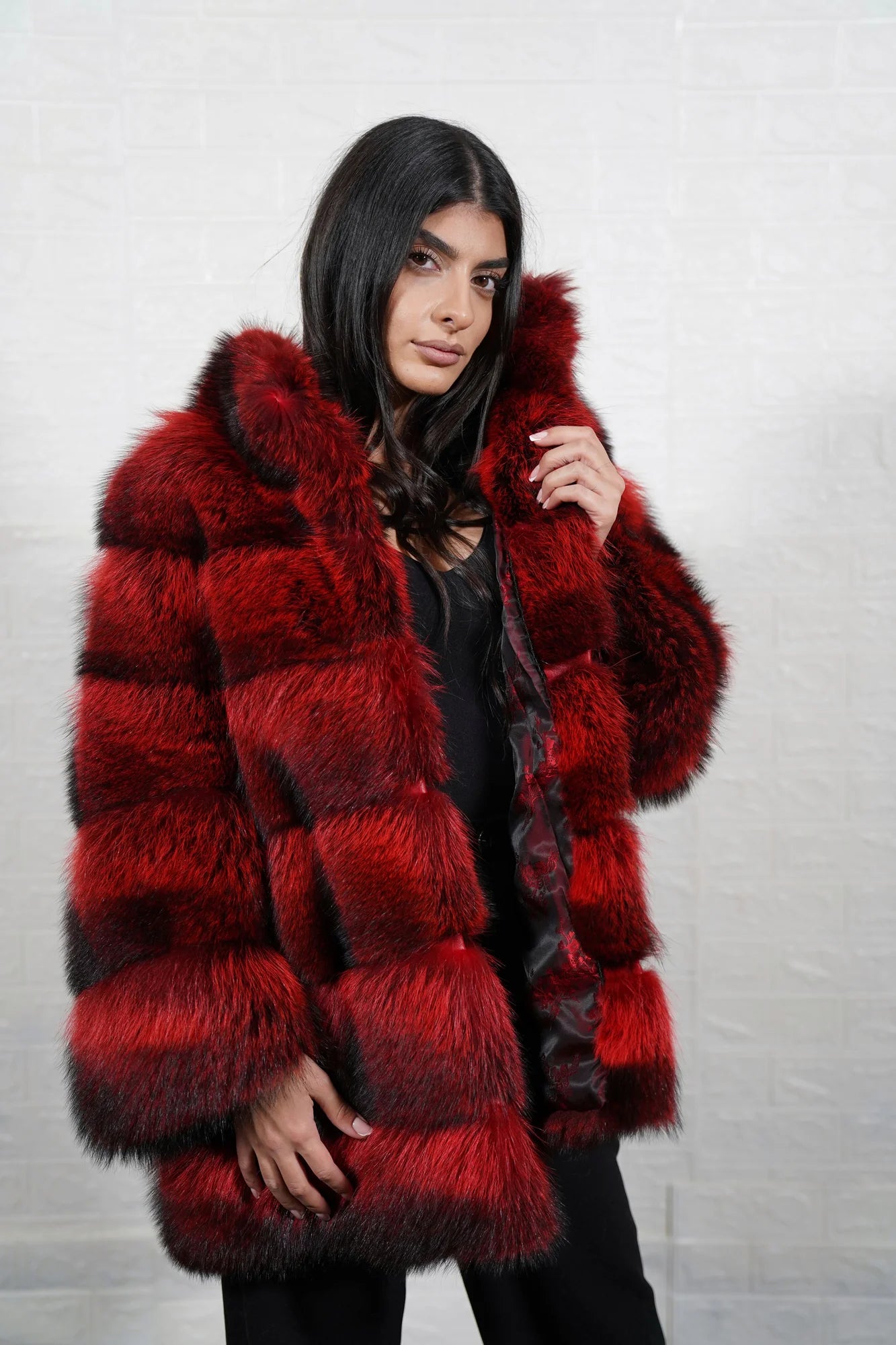 Raccoon fur jacket red black shown from the back displaying full below hip silhouette and consistent fierce red black raccoon full skin surface — Greek craftsmanship, TatiFurs
