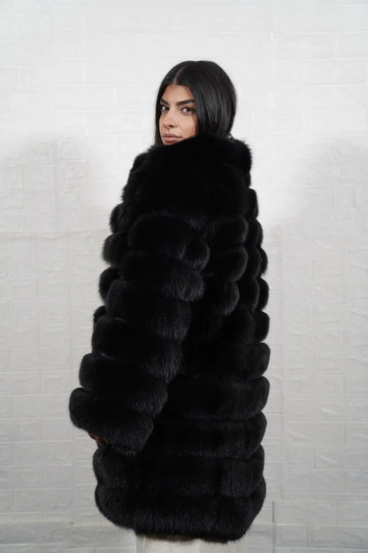 Fox fur coat black women shown full length from front displaying collarless neckline and button closure in horizontal leather framed black fox rows — Greek craftsmanship, TatiFurs
