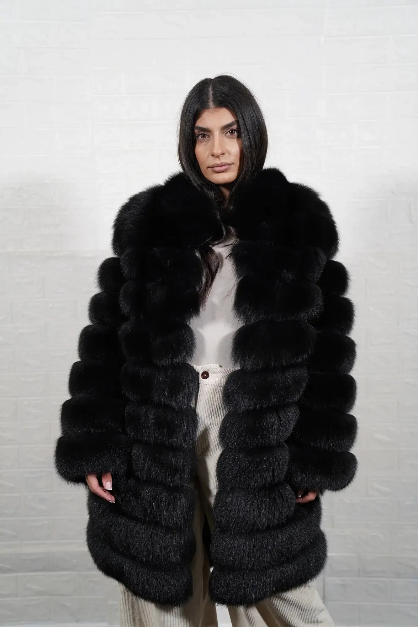 Fox fur coat black shown from the side displaying knee length silhouette and horizontal leather framed expressive black fox rows — Greek craftsmanship, TatiFurs
