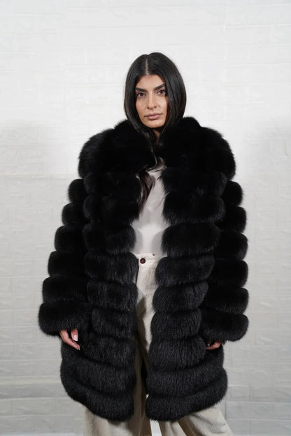 Fox fur coat black shown from the side displaying knee length silhouette and horizontal leather framed expressive black fox rows — Greek craftsmanship, TatiFurs
