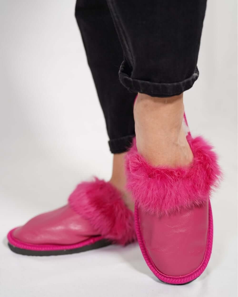 Sheepskin Wool Leather Fur Slippers Fuchsia for Women worn by model, showcasing comfort and luxury in vibrant pink.