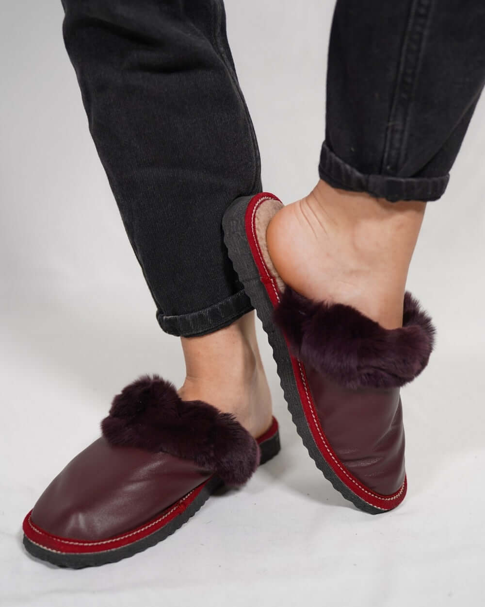 Sheepskin Wool Leather Fur Slippers Burgundy - Tatifurs on a model's feet, showcasing luxurious comfort and style.