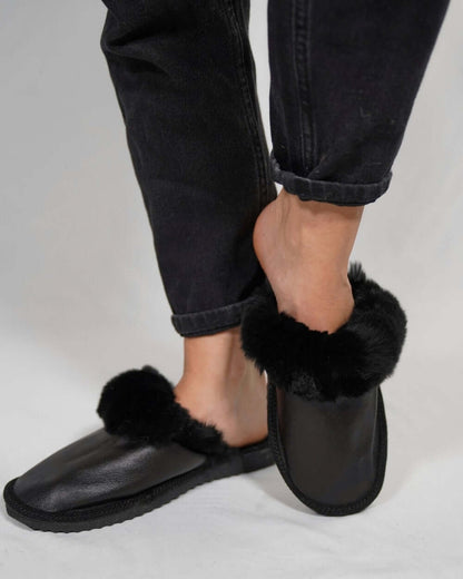 Leather Sheepskin Slippers Black - Tatifurs worn with black jeans, showcasing comfort and luxury.