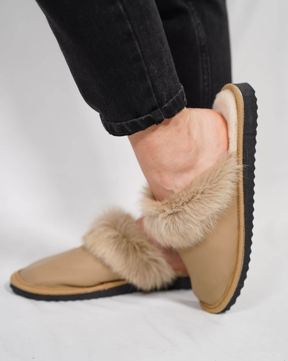 Sheepskin Wool Leather Fur Slippers Camel for Women worn on a person's feet, showcasing comfort and style.