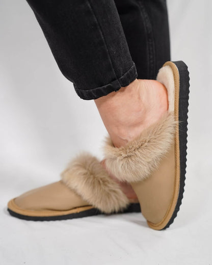 Sheepskin Wool Leather Fur Slippers Camel for Women worn on a person's feet, showcasing comfort and style.