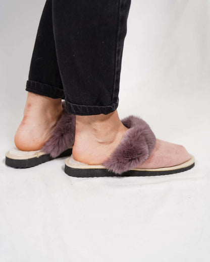Sheepskin Wool Slippers Baby Pink for Women - Tatifurs worn with black pants, showcasing luxurious comfort and style.