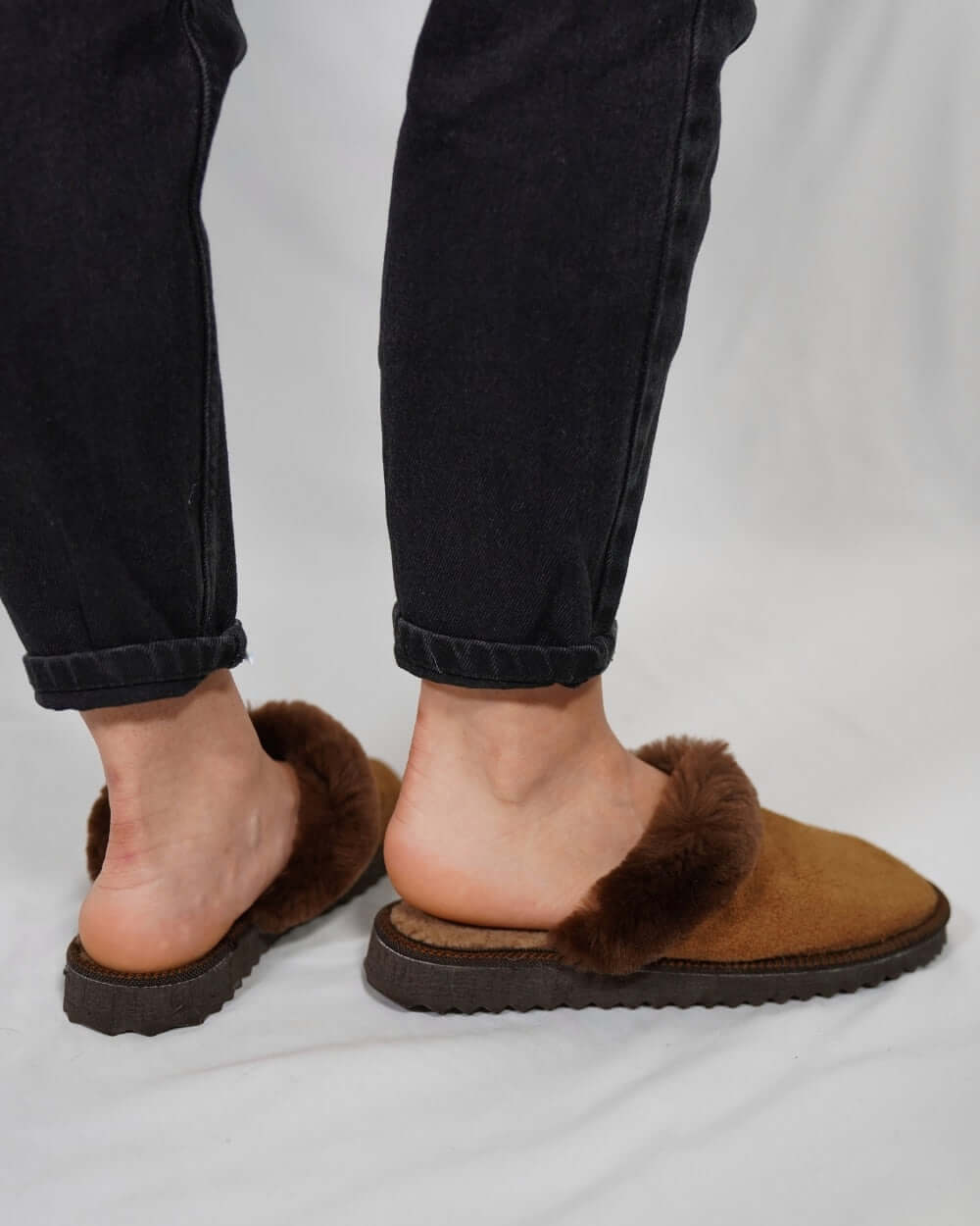 Sheepskin Wool Leather Fur Slippers Brown - Tatifurs worn by a model, showcasing comfort and style in luxurious footwear.