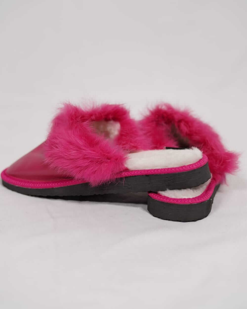 Sheepskin Wool Leather Fur Slippers Fuchsia for Women side view showcasing luxurious pink fur and leather design.