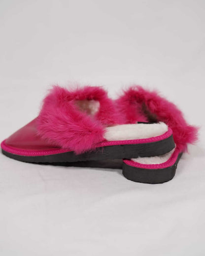 Sheepskin Wool Leather Fur Slippers Fuchsia for Women side view showcasing luxurious pink fur and leather design.