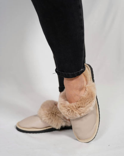 Sheepskin Wool Leather Slippers Beige - Tatifurs worn on feet, showing luxurious design and cozy fur lining.